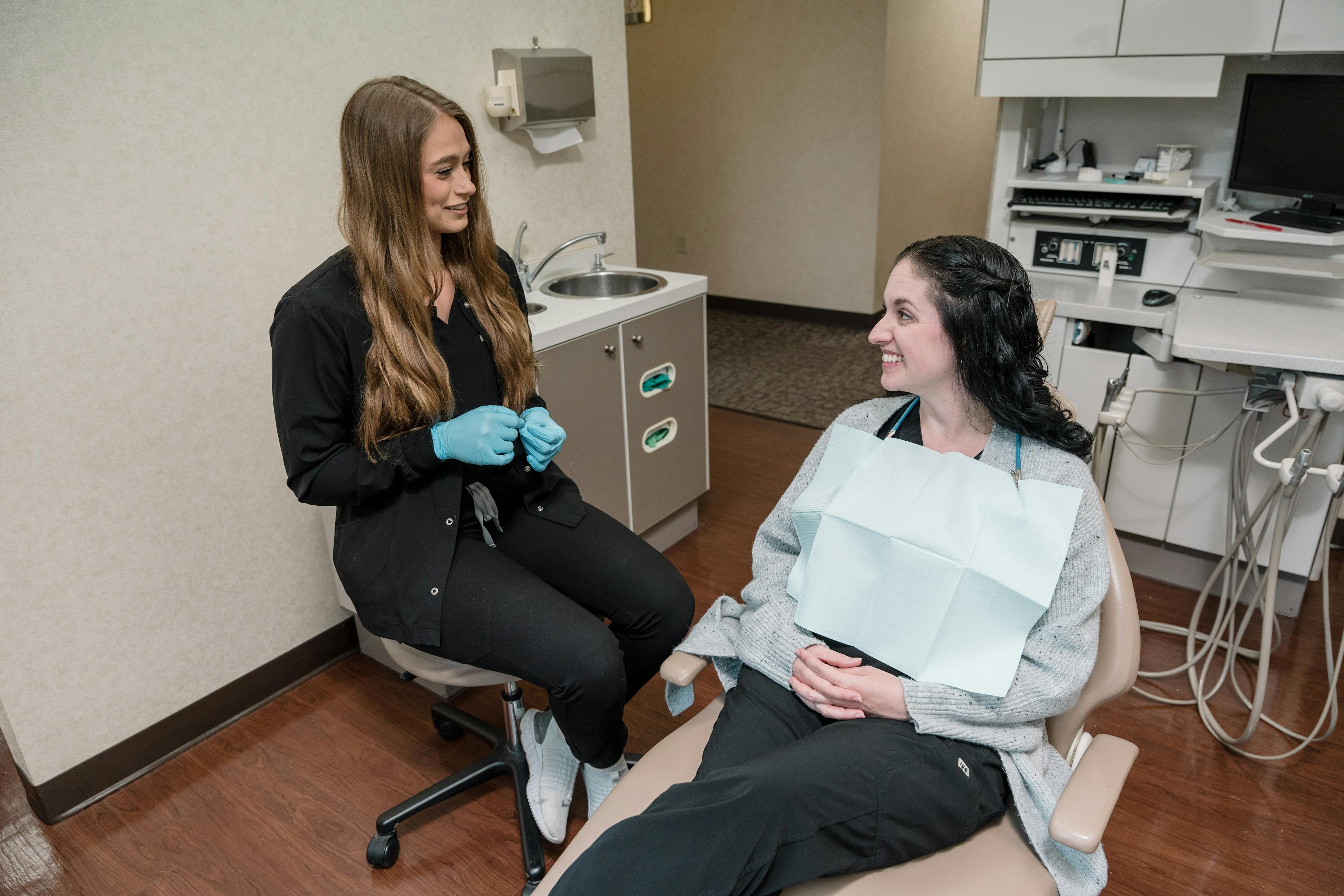 Smiling dental professional conducting a comprehensive initial exam, reflecting our commitment to quality care at Noblesville Family Dental.